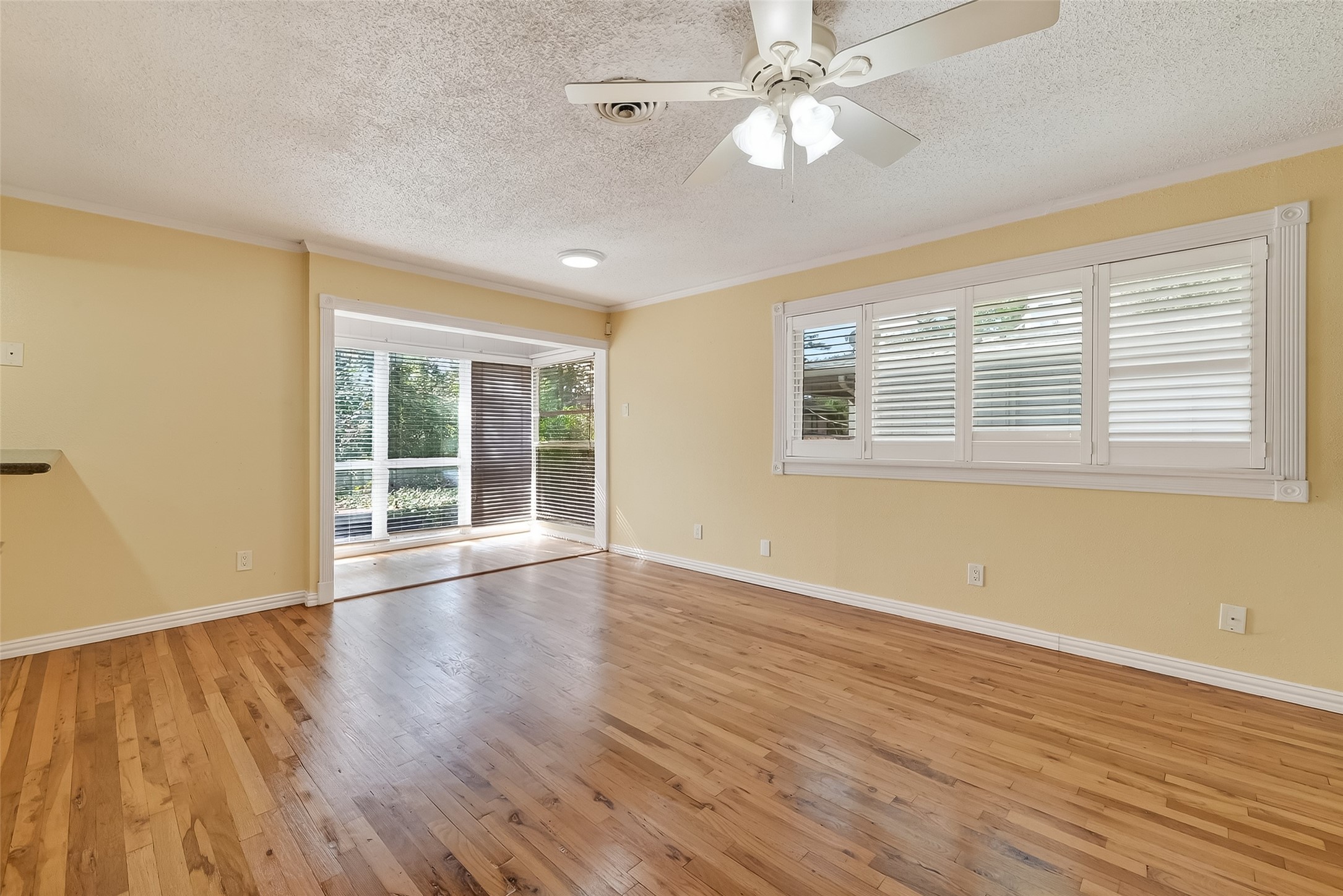 909 Silber Road, Unit 16C Houston, TX 77024 - Photo 6 of 32 a view of an empty room with wooden floor and a window