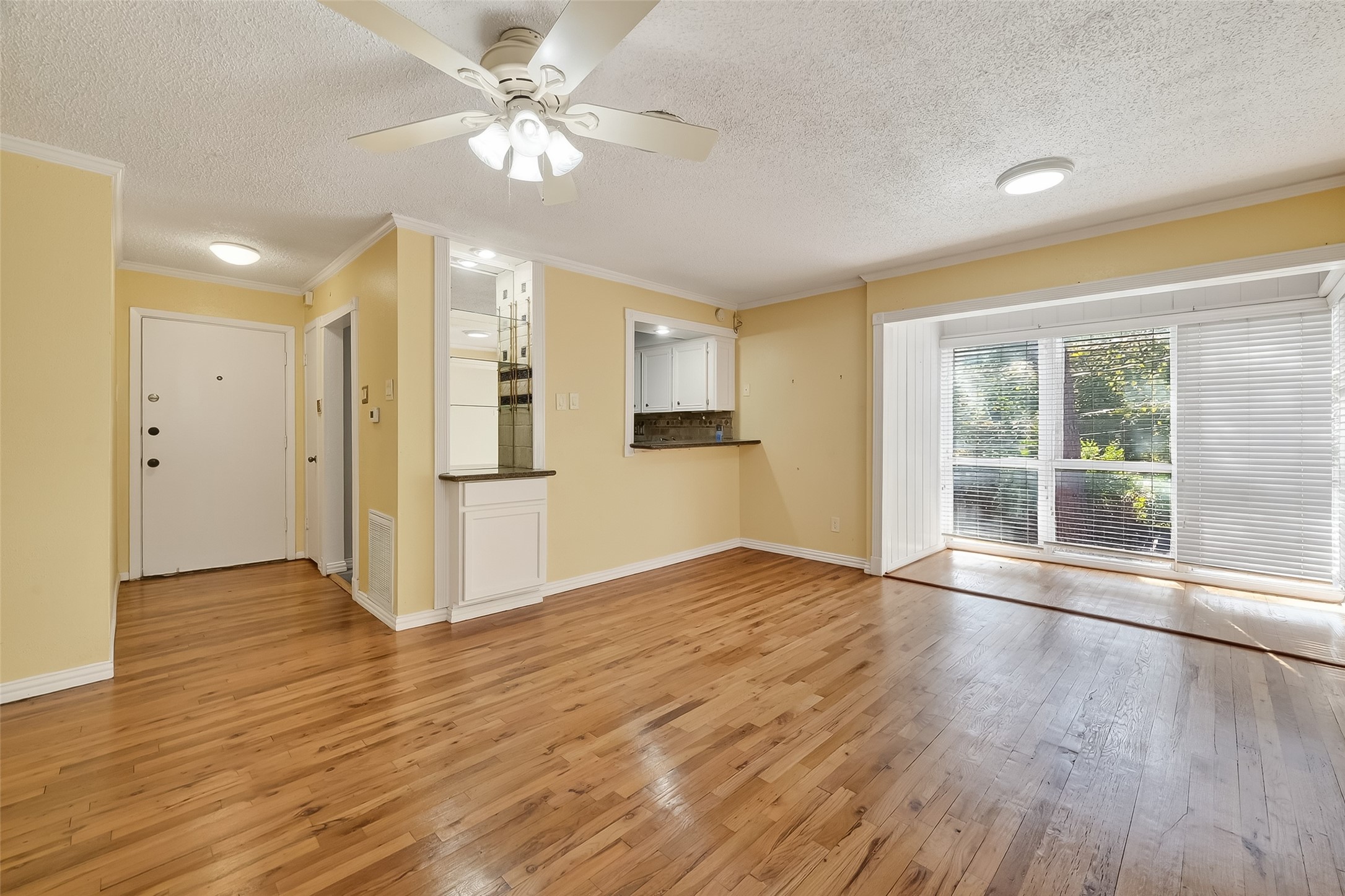 909 Silber Road, Unit 16C Houston, TX 77024 - Photo 7 of 32 a view of an empty room with window and wooden floor