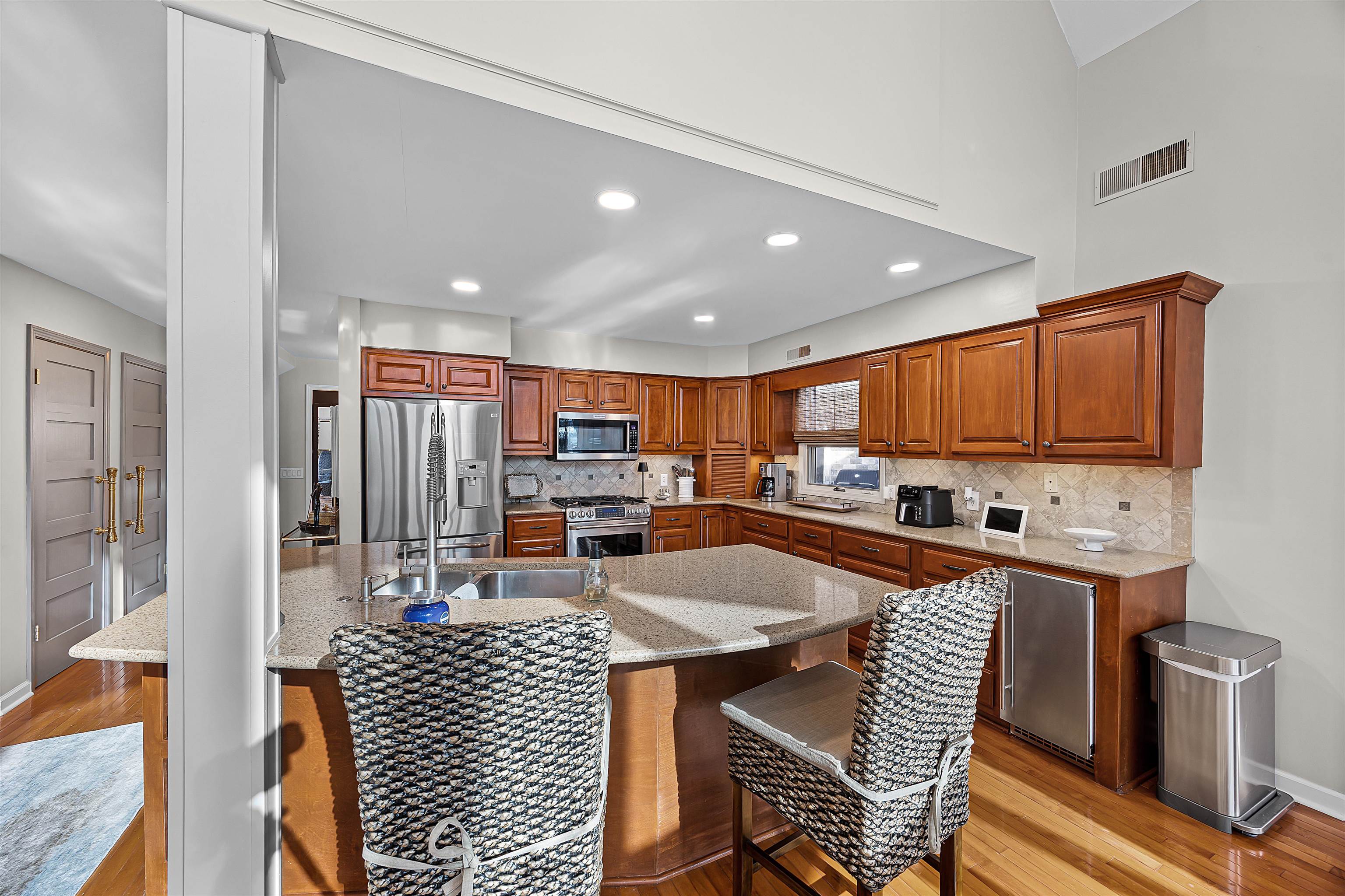 195 Ridge View Savannah, TN 38372 - Photo 14 of 40 a kitchen with stainless steel appliances kitchen island granite countertop a dining table chairs and a refrigerator