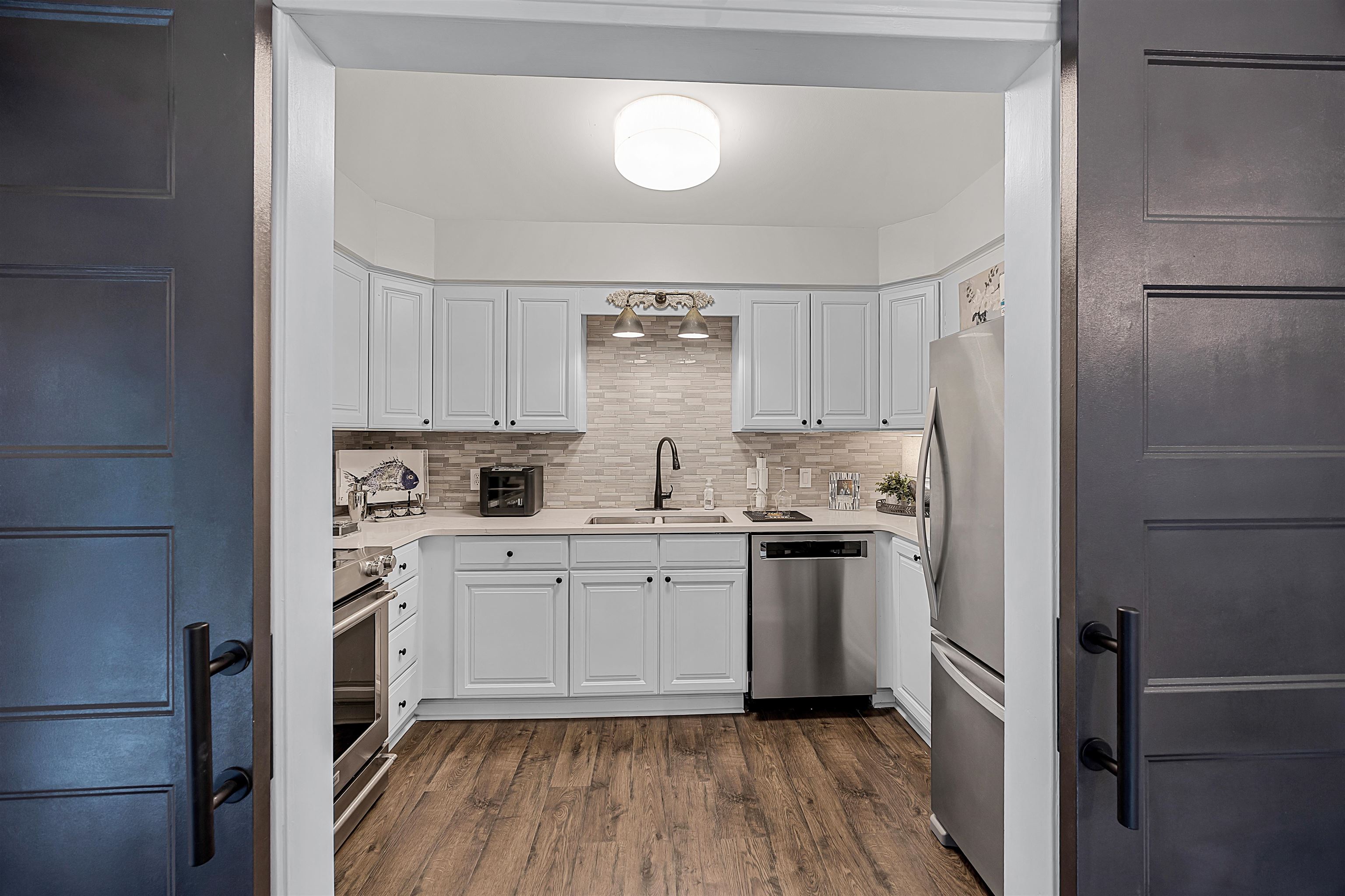 195 Ridge View Savannah, TN 38372 - Photo 20 of 40 a kitchen with a white cabinets and wooden floor