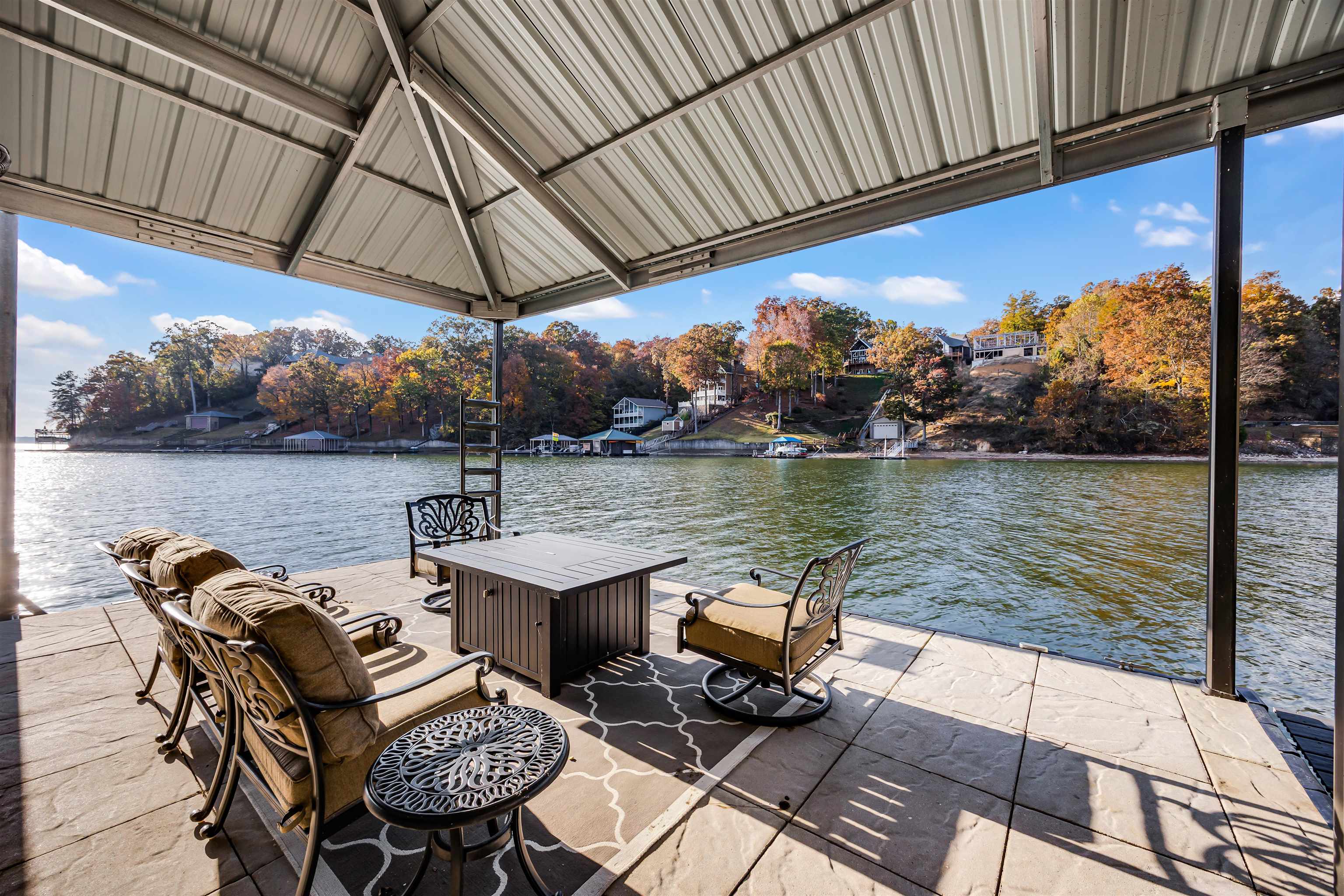 195 Ridge View Savannah, TN 38372 - Photo 37 of 40 a view of a lake with couches chairs under an umbrella