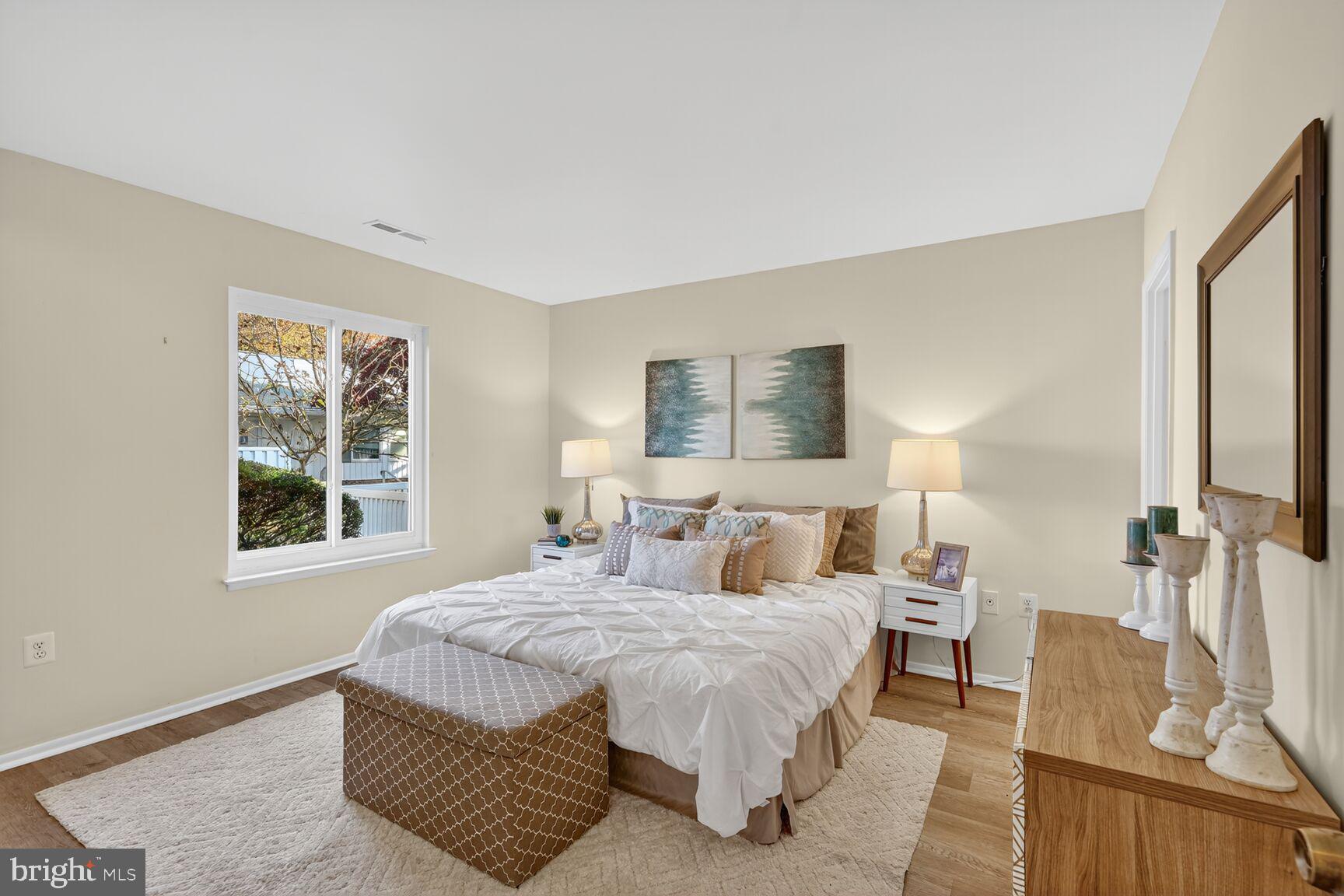 3110 Adderley Court, Unit 245A Silver Spring, MD 20906 - Photo 12 of 31 a bedroom with a bed and wooden floor