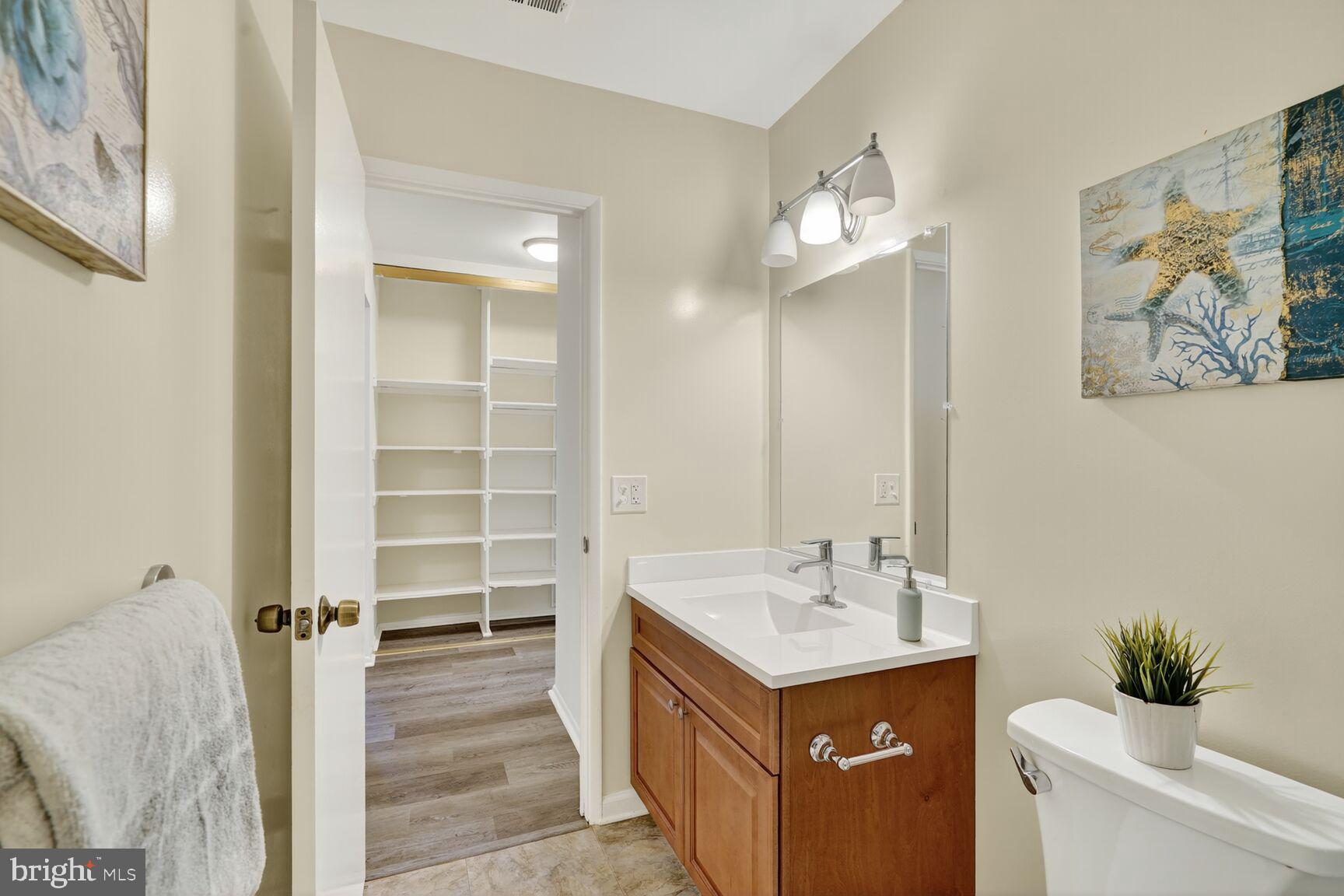 3110 Adderley Court, Unit 245A Silver Spring, MD 20906 - Photo 15 of 31 a bathroom with a sink a toilet and a mirror