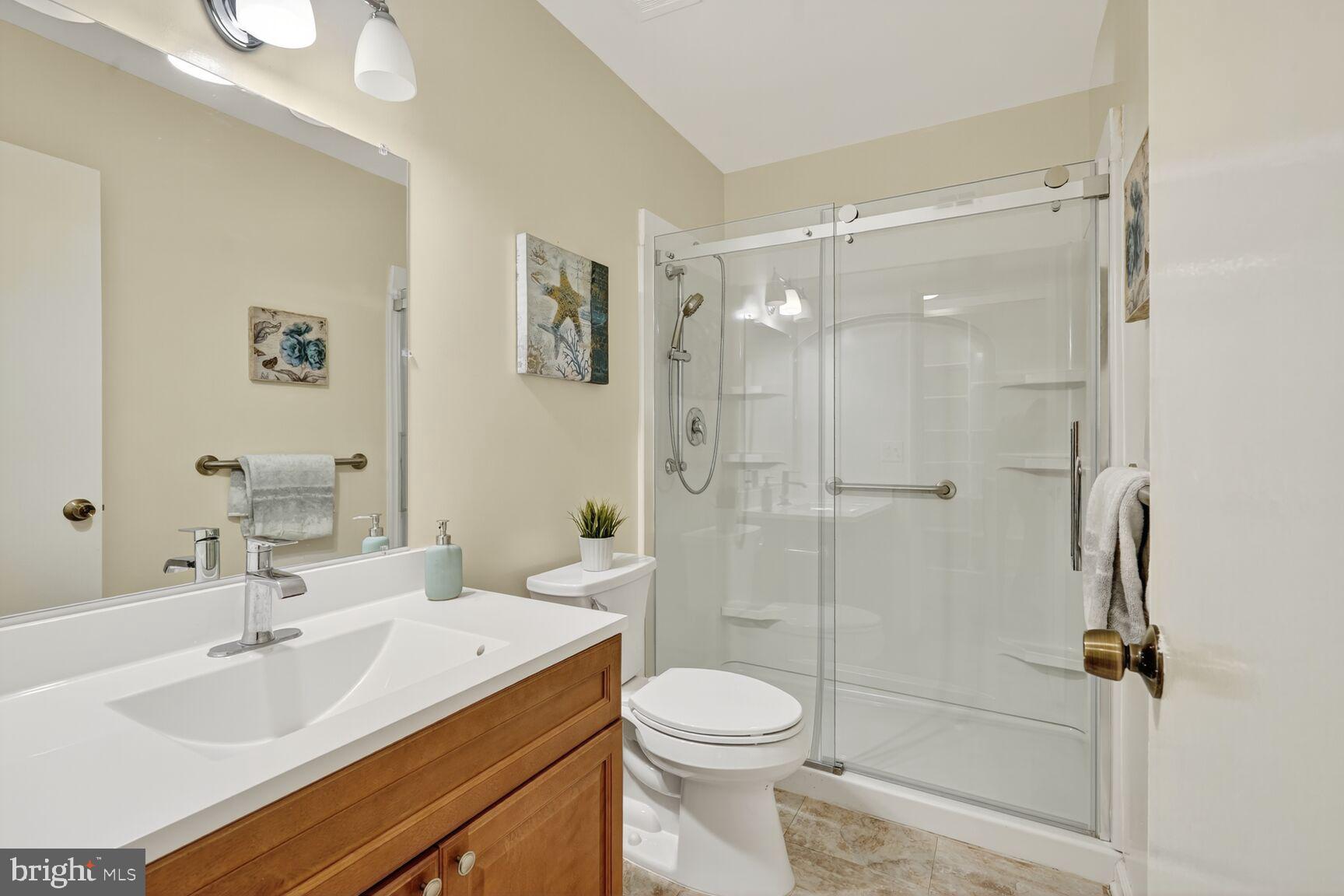 3110 Adderley Court, Unit 245A Silver Spring, MD 20906 - Photo 16 of 31 a bathroom with a sink toilet vanity and shower