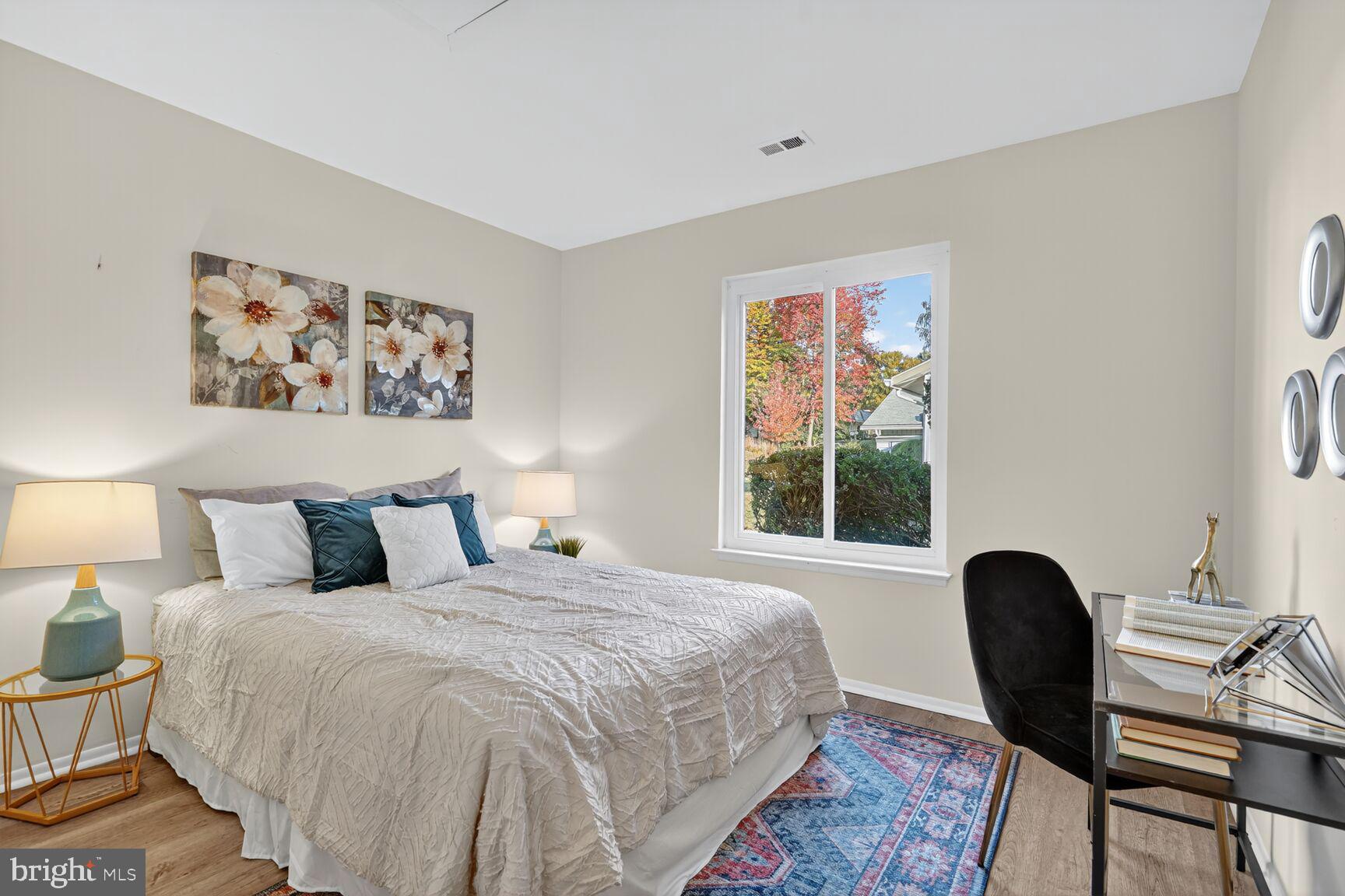 3110 Adderley Court, Unit 245A Silver Spring, MD 20906 - Photo 17 of 31 a bedroom with a bed lamps and a window