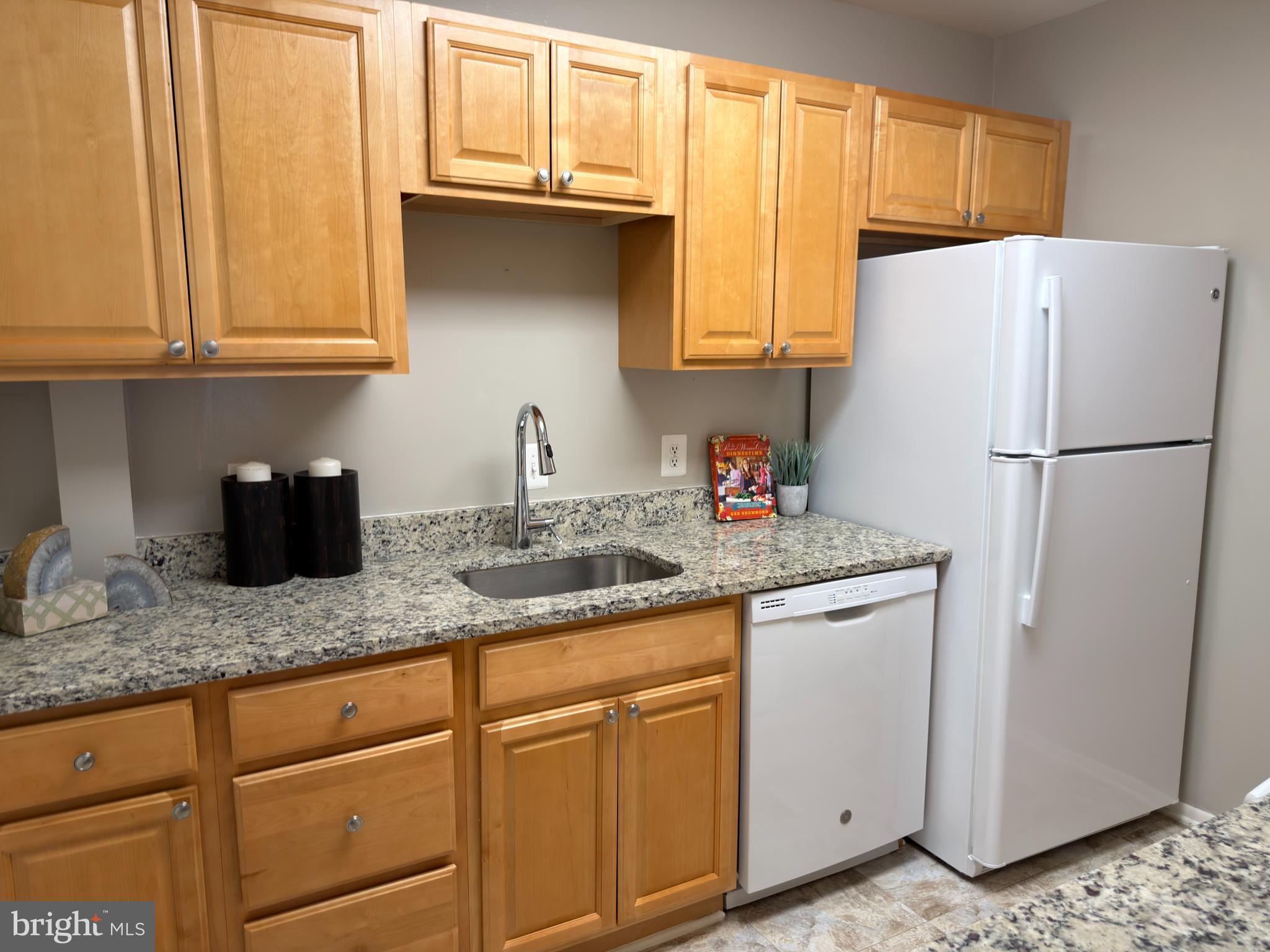 3110 Adderley Court, Unit 245A Silver Spring, MD 20906 - Photo 9 of 31 a white refrigerator freezer sitting inside of a kitchen