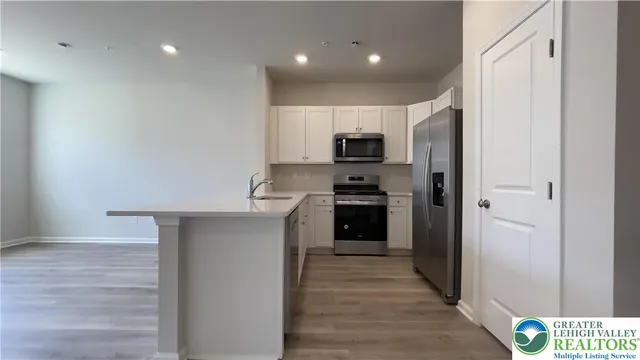 a kitchen with a refrigerator stove and microwave