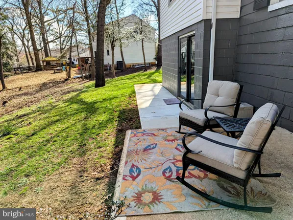 a view of a house with a large tree and a yard