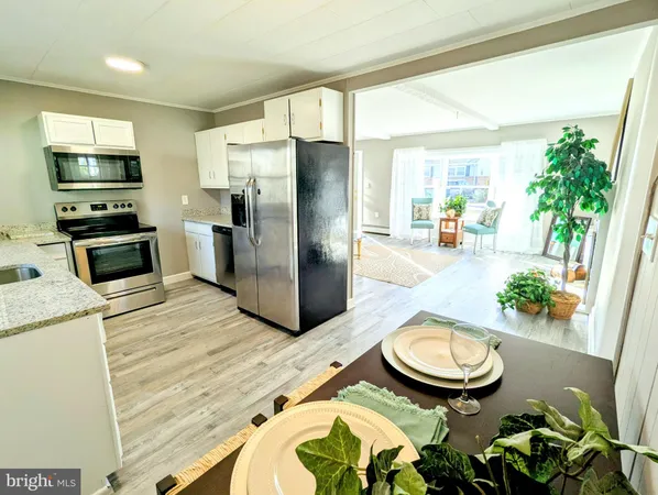 a kitchen with granite countertop a refrigerator and a sink