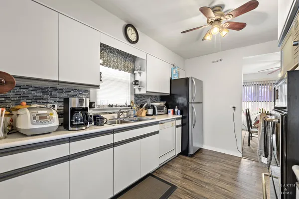 a kitchen with stainless steel appliances granite countertop a stove and a refrigerator
