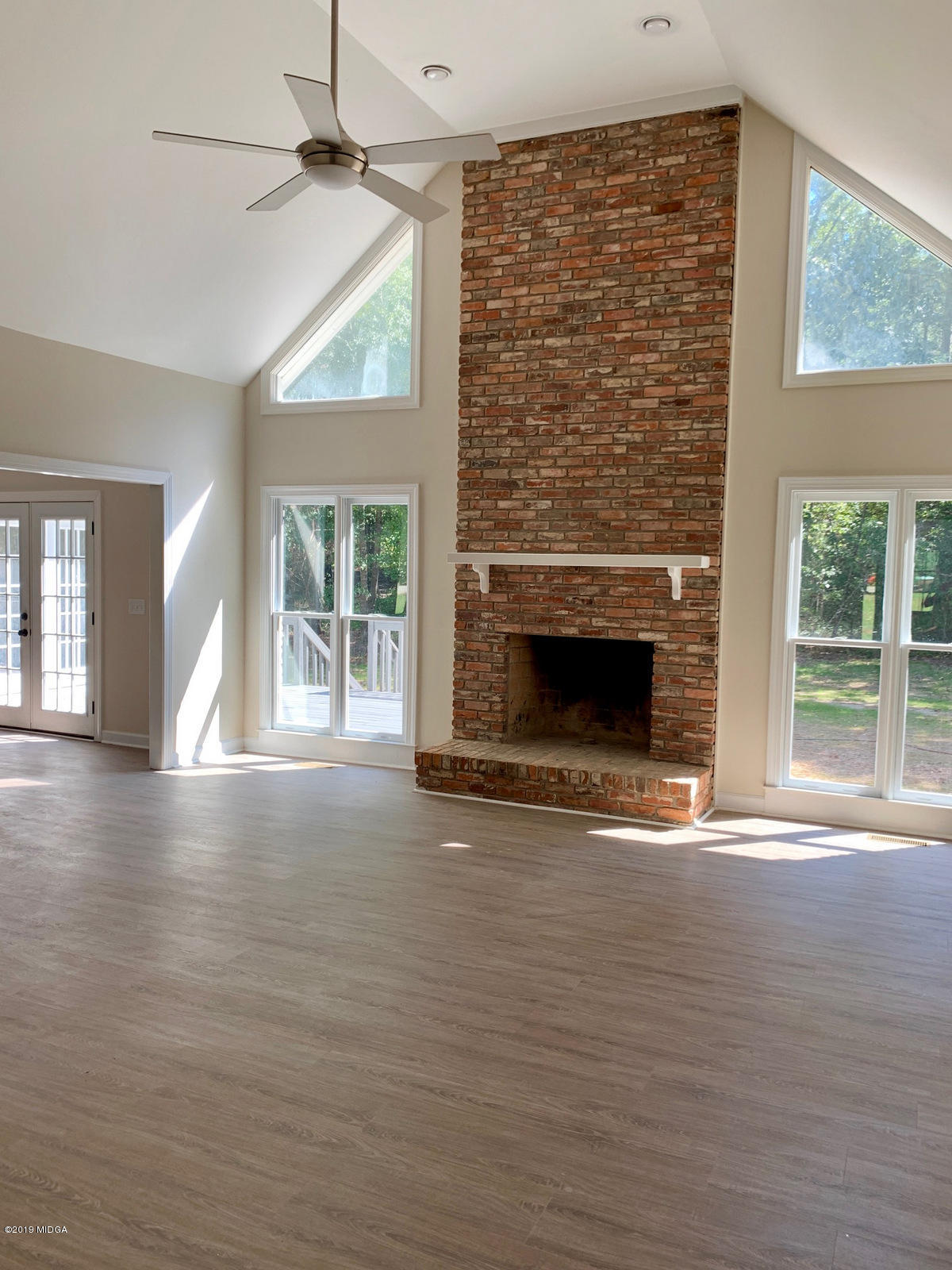 140 Hampton Ridge Road Macon, GA 31220 - Photo 3 of 19 a view of empty room with wooden floor and fireplace