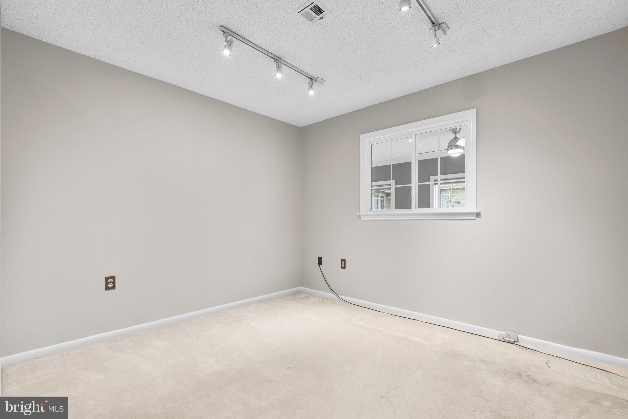 3415 Island Creek Court, Unit 131A Silver Spring, MD 20906 - Photo 27 of 32 an empty room with windows