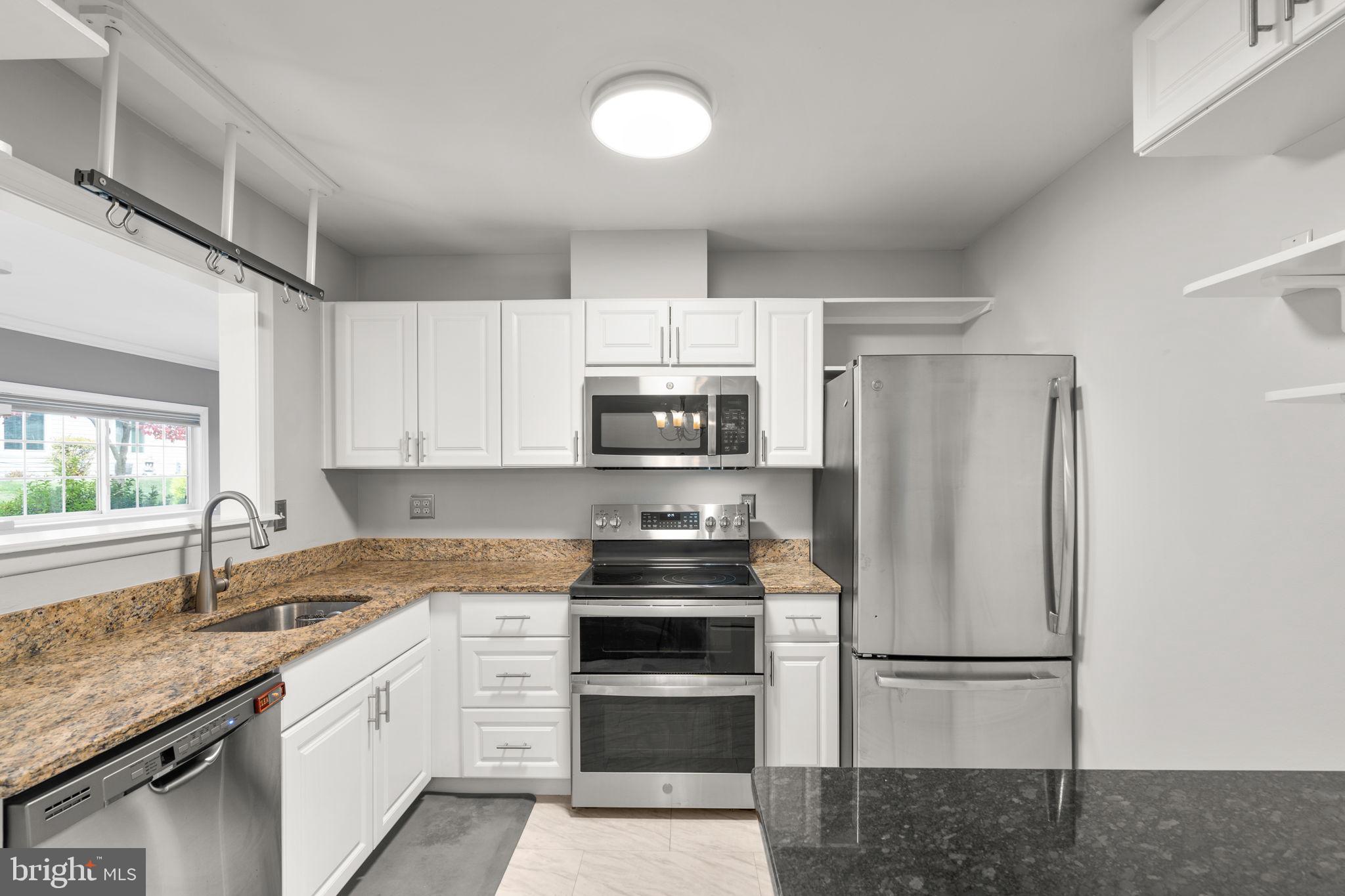 3415 Island Creek Court, Unit 131A Silver Spring, MD 20906 - Photo 8 of 32 a kitchen with stainless steel appliances granite countertop a refrigerator sink and stove