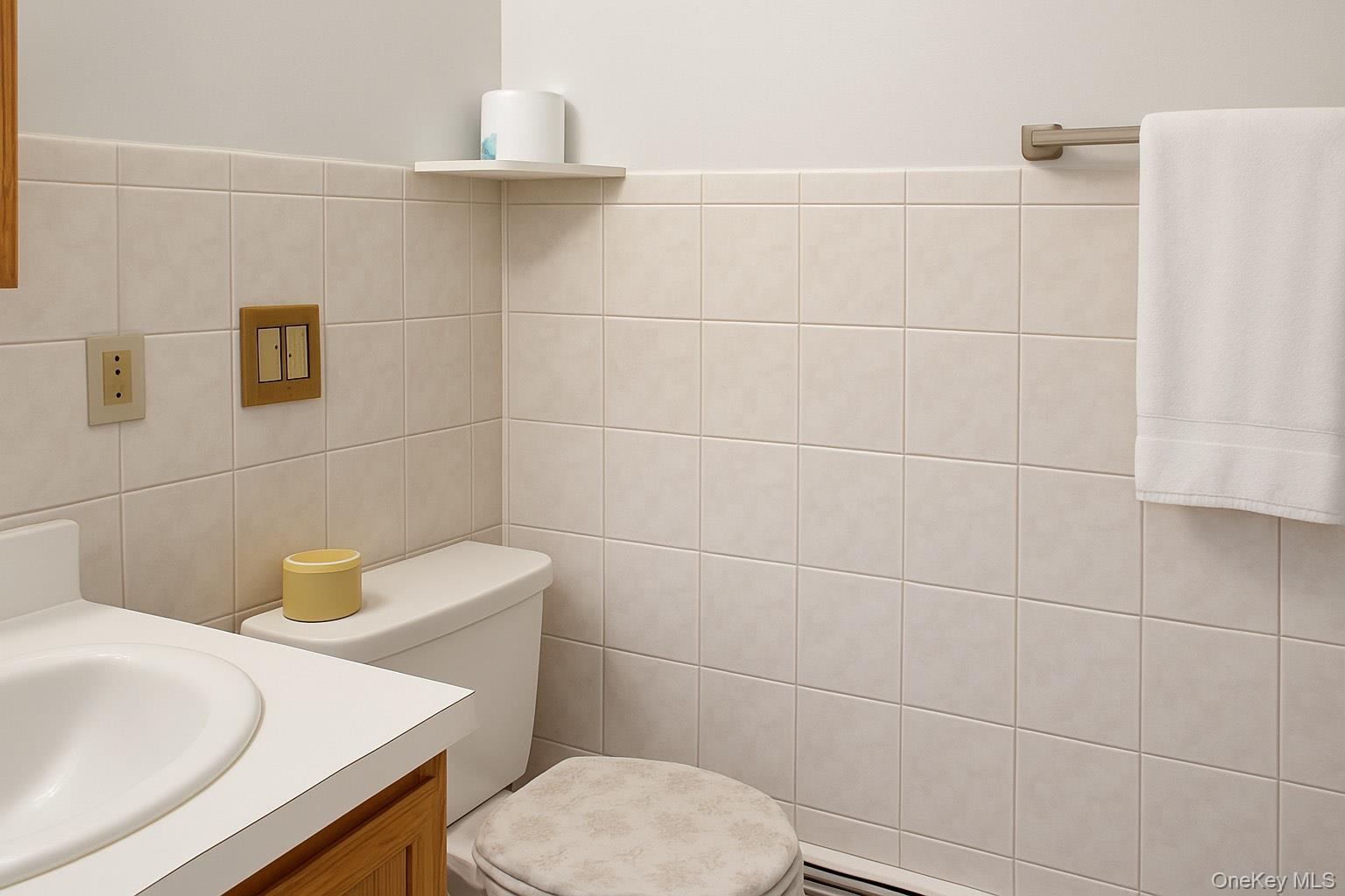 107-04 Guy R Brewer Boulevard, Unit 7A Queens, NY 11433 - Photo 5 of 8 a bathroom with a sink a toilet and a mirror