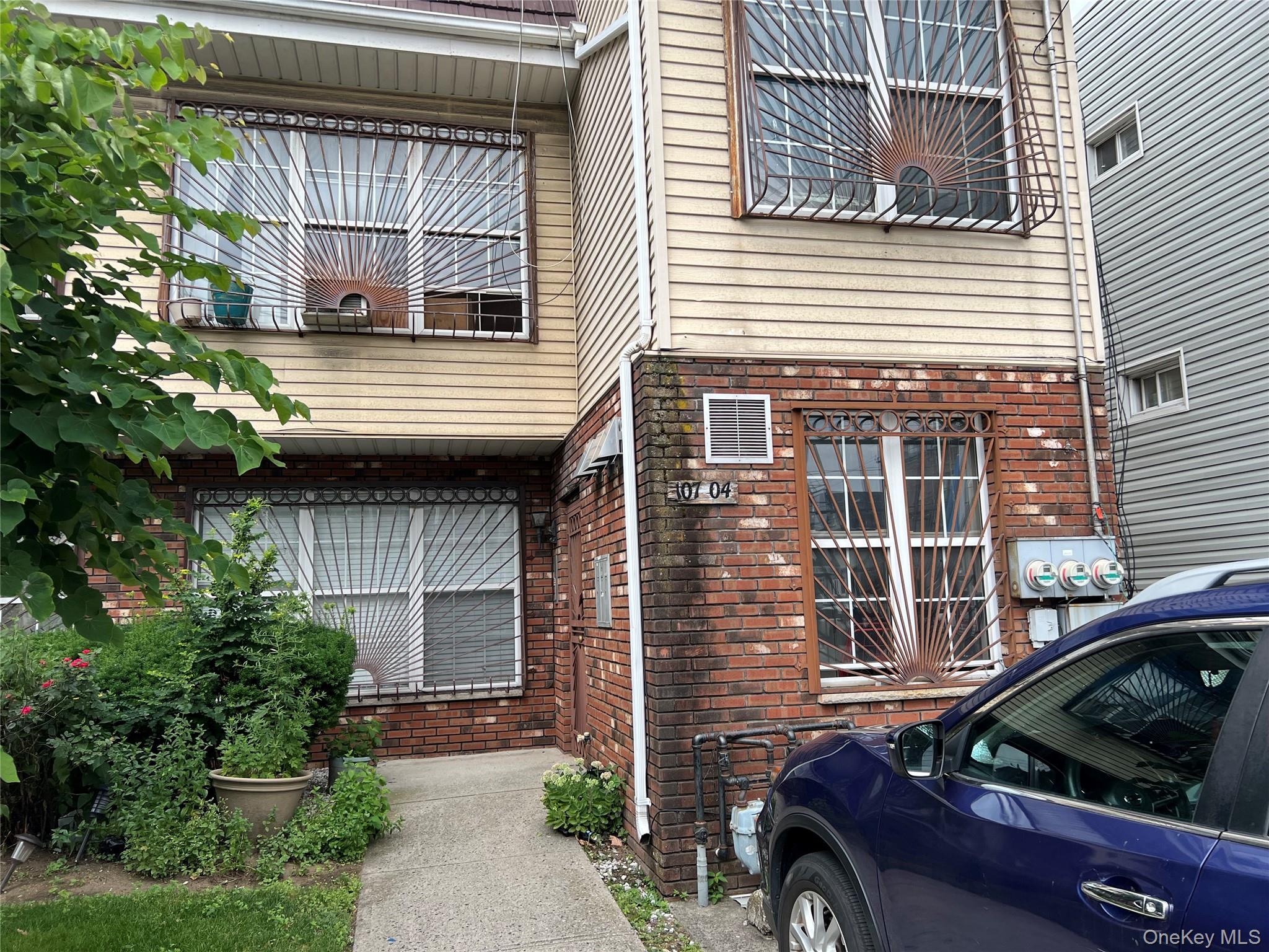 107-04 Guy R Brewer Boulevard, Unit 7A Queens, NY 11433 - Photo 8 of 8 a car parked in front of a house
