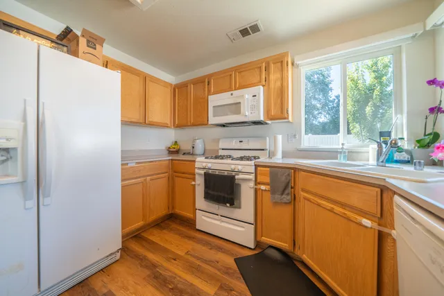 a kitchen with stainless steel appliances a stove sink and cabinets