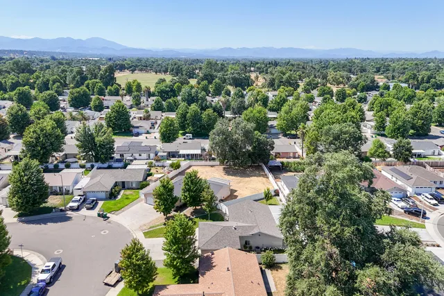 an aerial view of a house with a yard