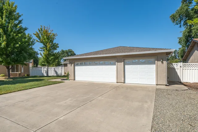 a view of a house with a yard and garage