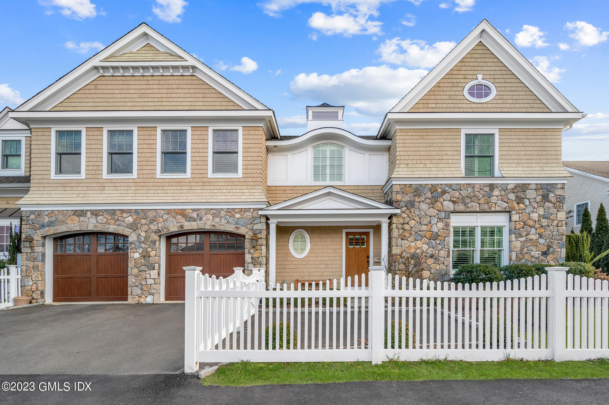 72 Havemeyer Place, Unit B Greenwich, CT 06830 - Photo 2 of 19 a front view of a house with a garage