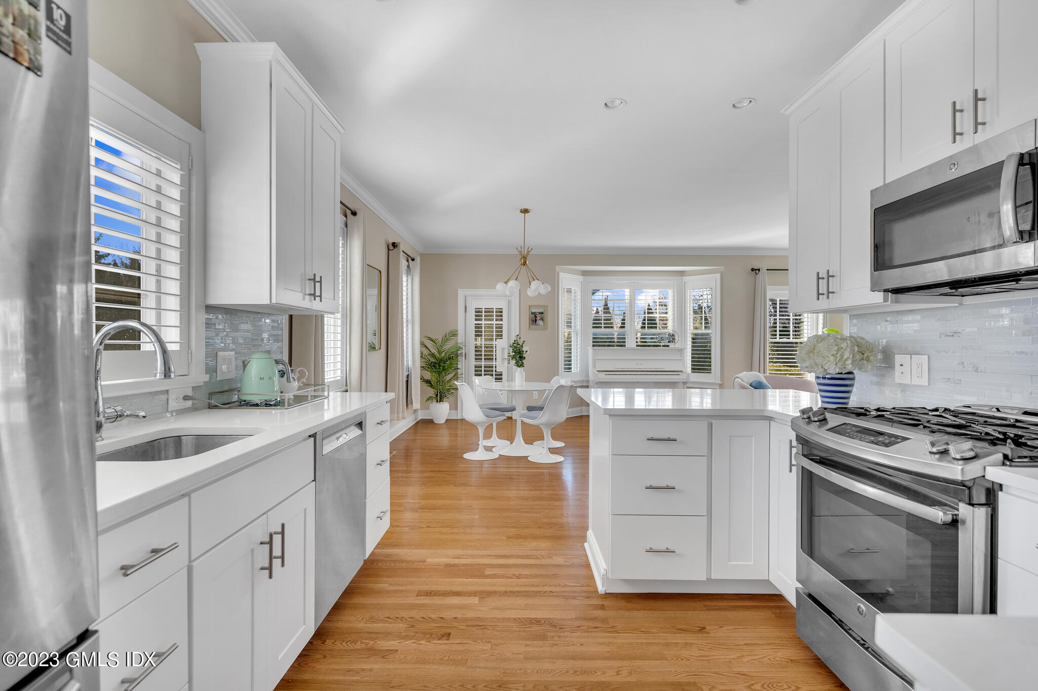 72 Havemeyer Place, Unit B Greenwich, CT 06830 - Photo 6 of 19 a large white kitchen with stainless steel appliances