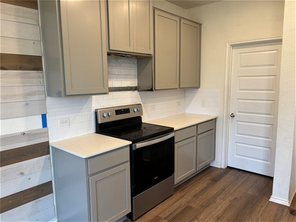 252 Benmyrtle Trail Georgetown, TX 78626 - Photo 5 of 17 a kitchen with a stove cabinets and wooden floor