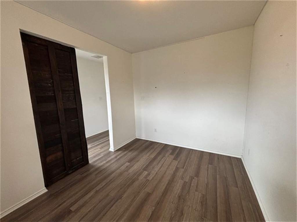 252 Benmyrtle Trail Georgetown, TX 78626 - Photo 8 of 17 an empty room with wooden floor and closet