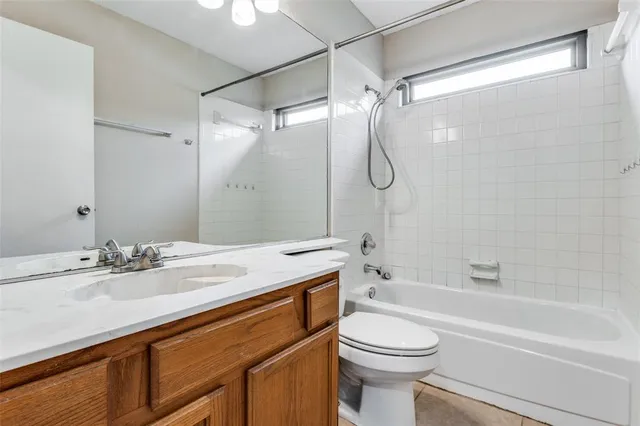 a bathroom with a sink vanity mirror and toilet