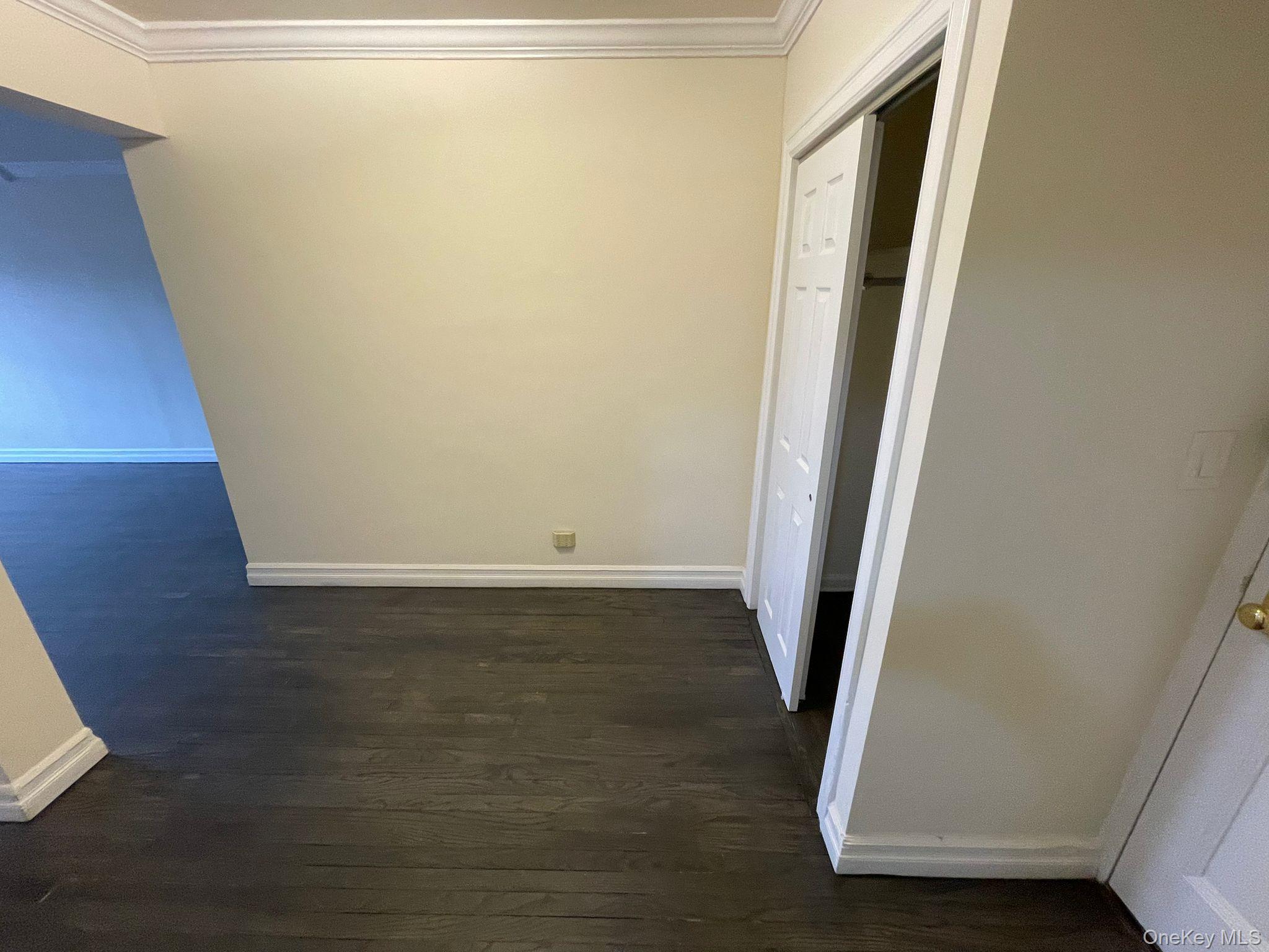 100-11 67th Road, Unit 4 Queens, NY 11375 - Photo 16 of 33 Hallway with dark wood-style floors and crown molding