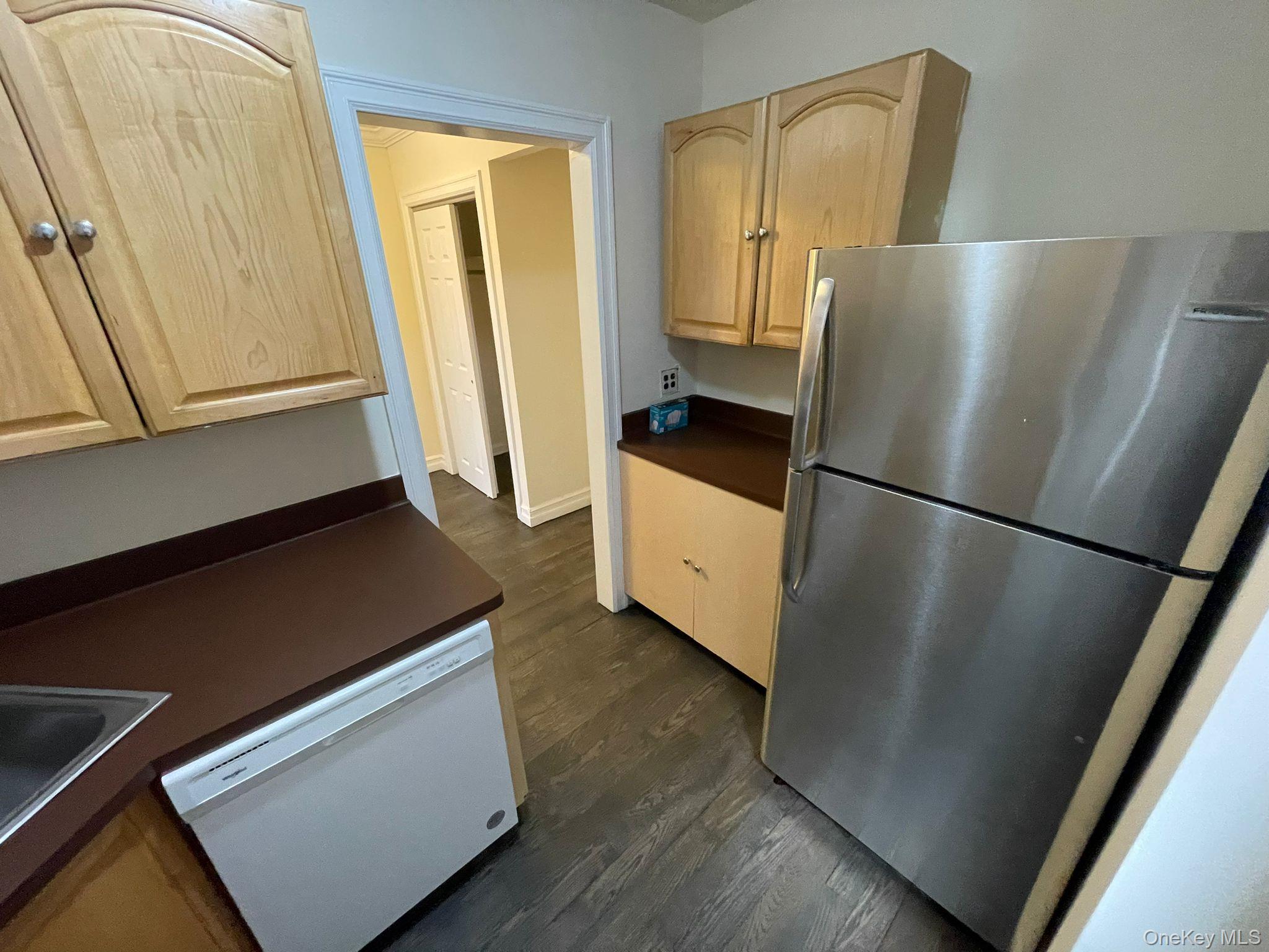 100-11 67th Road, Unit 4 Queens, NY 11375 - Photo 19 of 33 Kitchen featuring dark countertops, freestanding refrigerator, dishwasher, dark wood-style floors, and light brown cabinetry