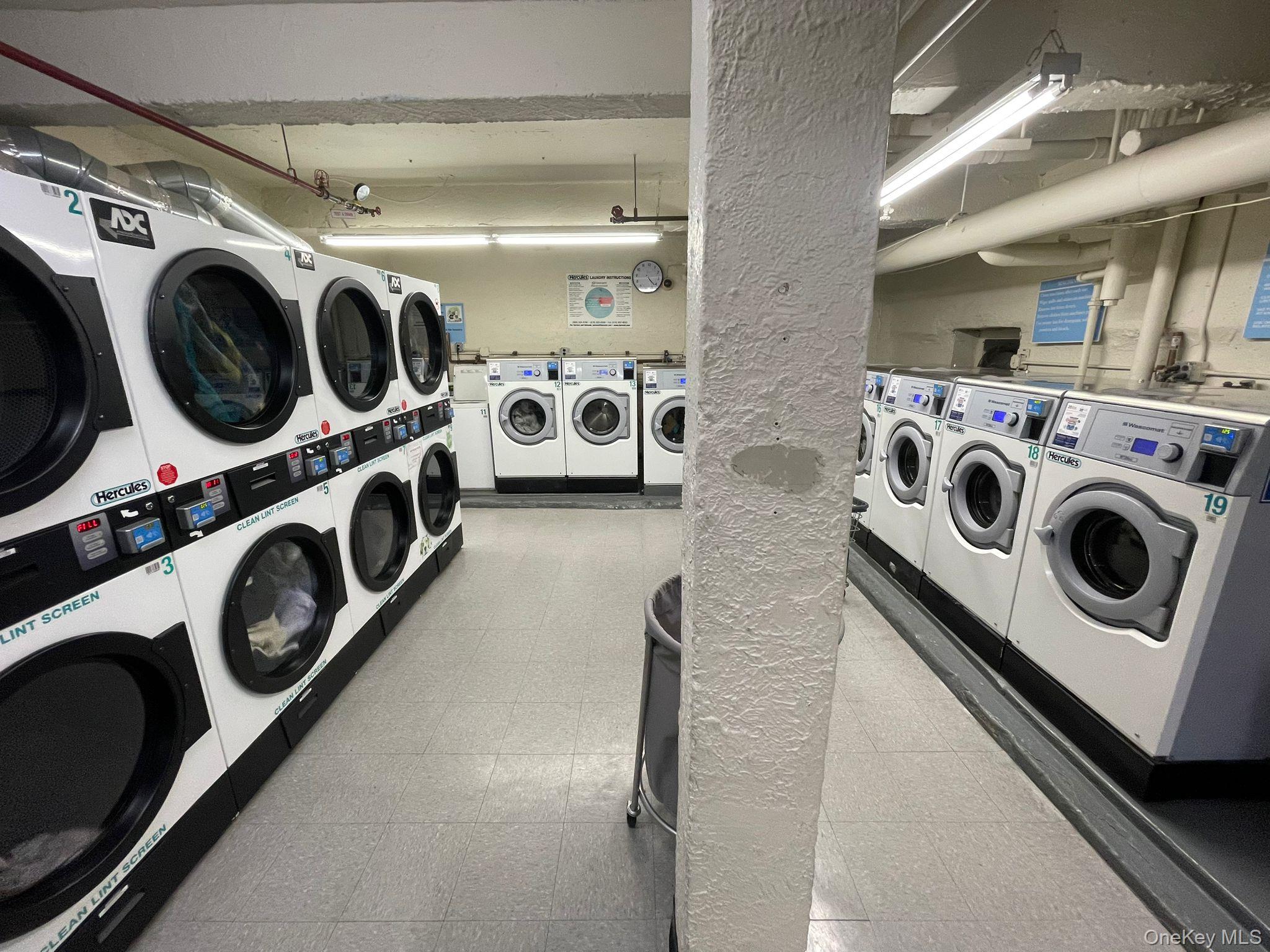 100-11 67th Road, Unit 4 Queens, NY 11375 - Photo 29 of 33 Shared laundry room featuring light floors, washing machine and clothes dryer, and stacked washer / drying machine