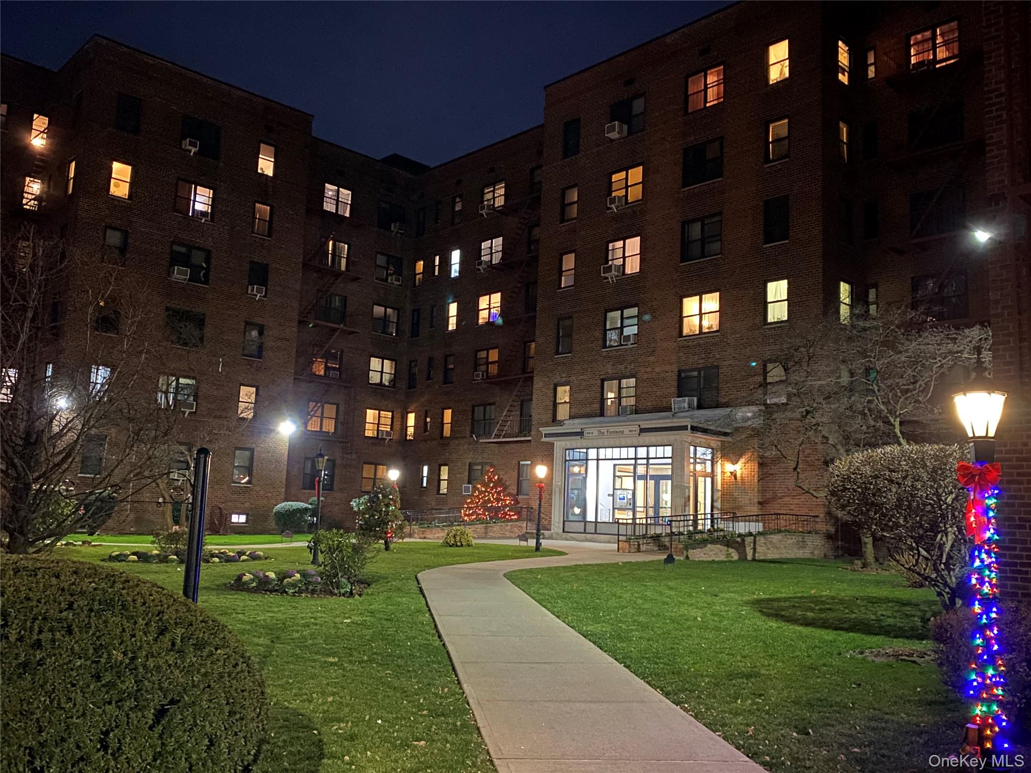 100-11 67th Road, Unit 4 Queens, NY 11375 - Photo 32 of 33 Surrounding community featuring a lawn