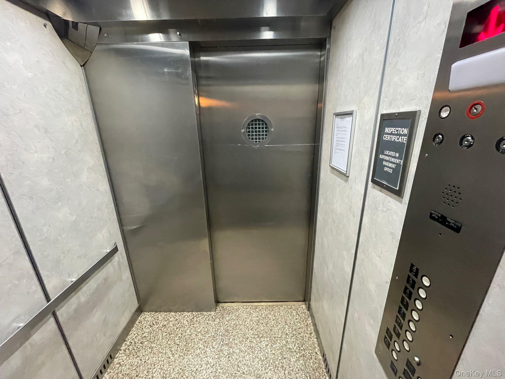100-11 67th Road, Unit 4 Queens, NY 11375 - Photo 8 of 33 Elevator with speckled floor and a textured wall