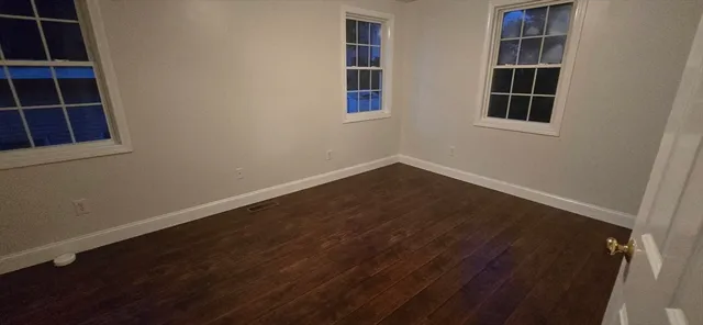 a view of wooden floor in an empty room
