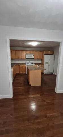 a kitchen with a white stove top oven and sink