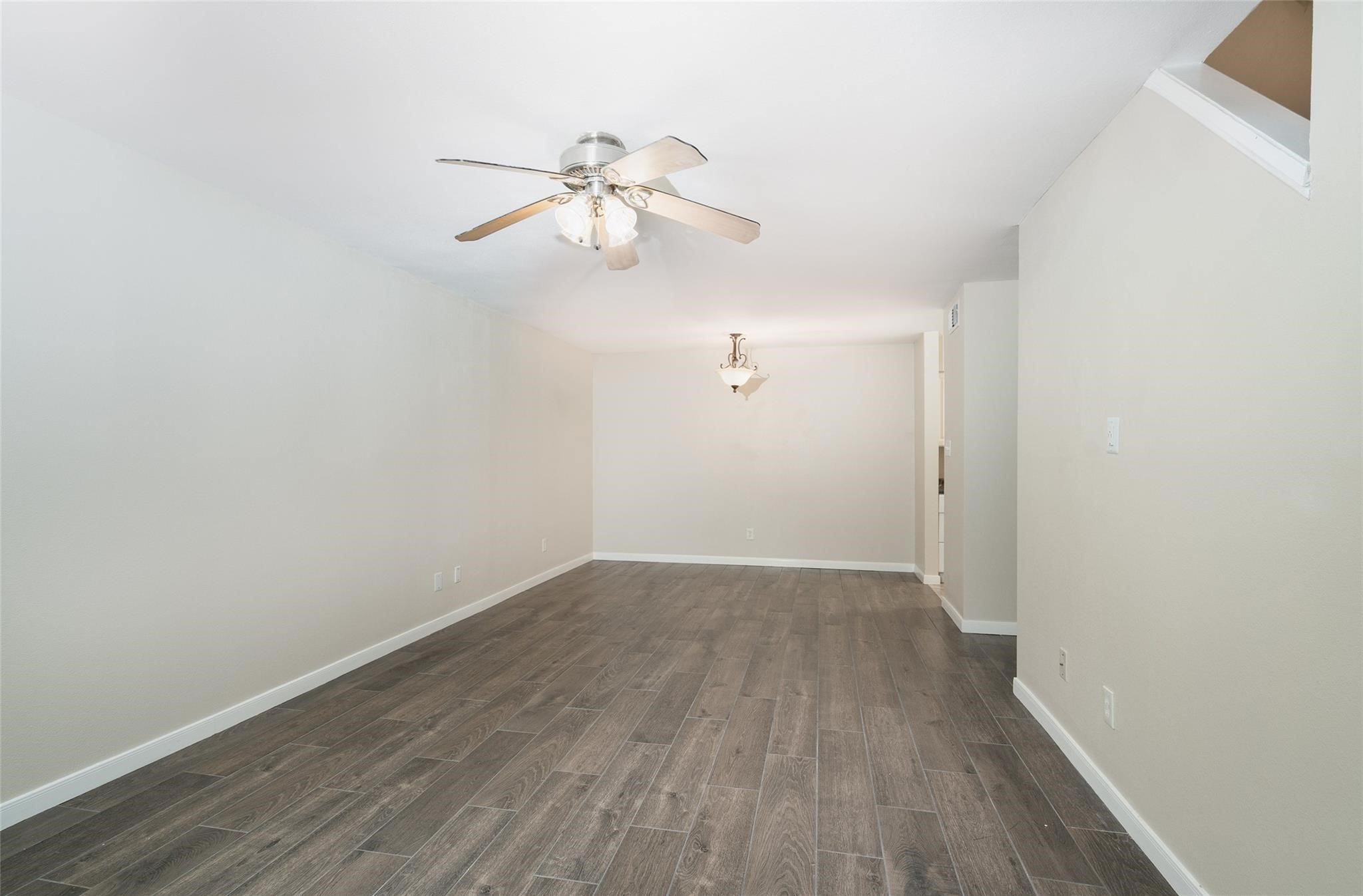 16120 Stuebner Airline Road, Unit 501 Spring, TX 77379 - Photo 15 of 23 an empty room with wooden floor fan and windows
