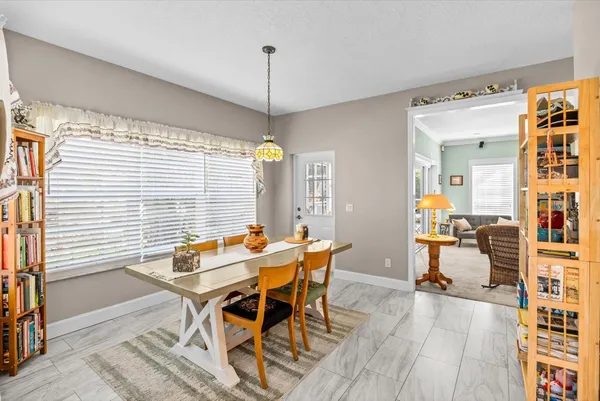 a kitchen with stainless steel appliances granite countertop a sink a stove and a wooden cabinets