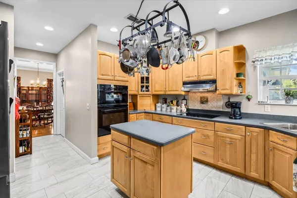 a kitchen with stainless steel appliances granite countertop a sink a stove and refrigerator