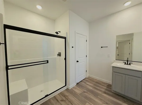 a bathroom with a shower sink and mirror