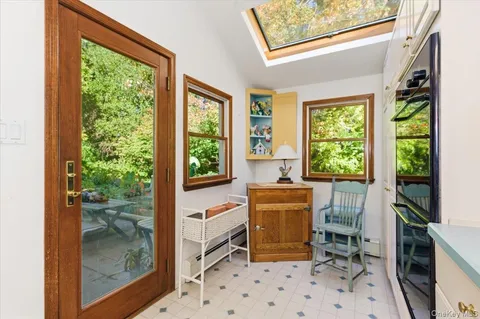 a room with furniture a large window and a fireplace