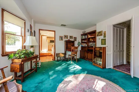 a view of a bedroom with furniture and windows