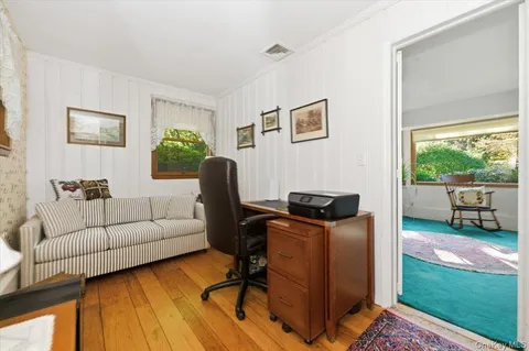 a livingroom with workspace window and a couch