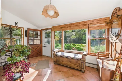 a living room filled with furniture and a large window