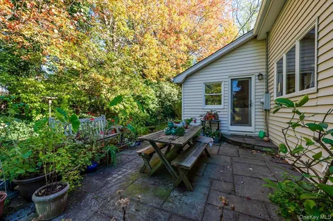 a view of a backyard with sitting area and garden