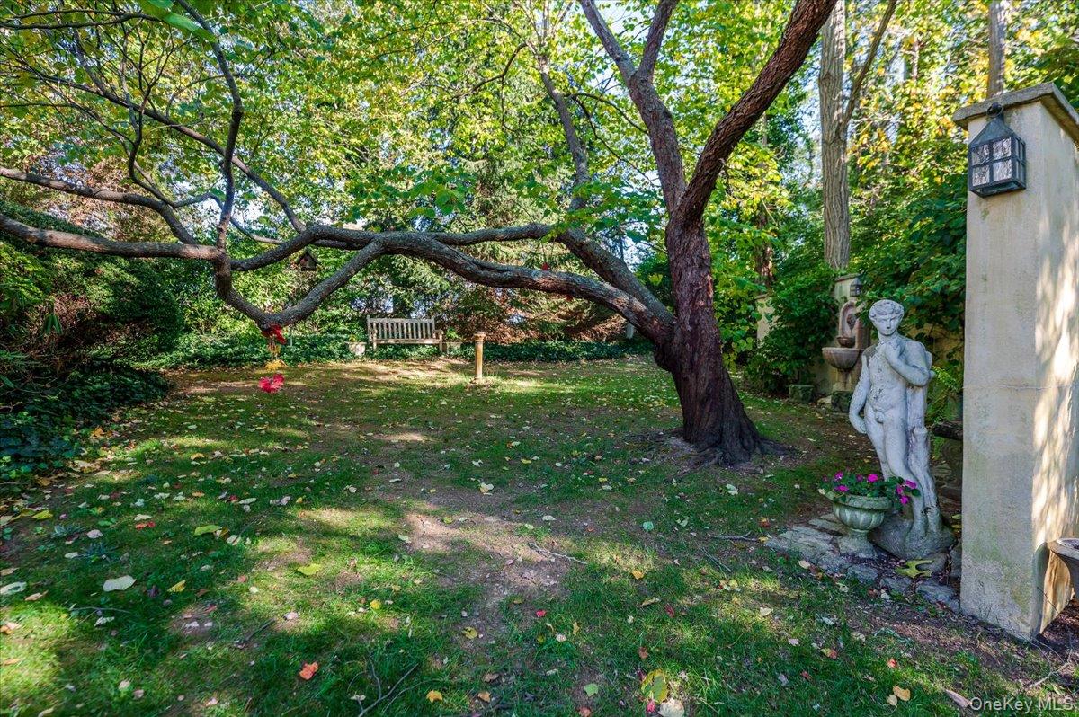 27 Cold Spring Hills Road Huntington, NY 11743 - Photo 34 of 48 a backyard of a house with lots of green space and garden view