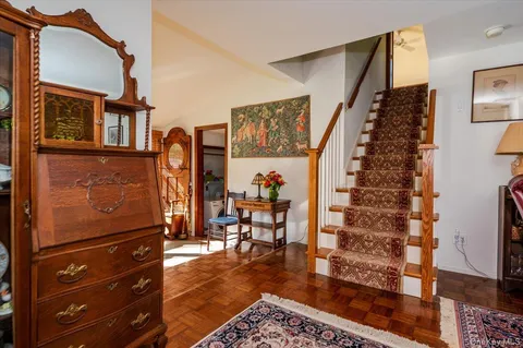 a view of a living room with furniture and wooden floor