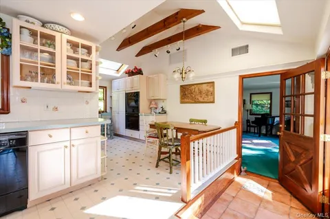 a kitchen with stainless steel appliances kitchen island granite countertop a sink and cabinets