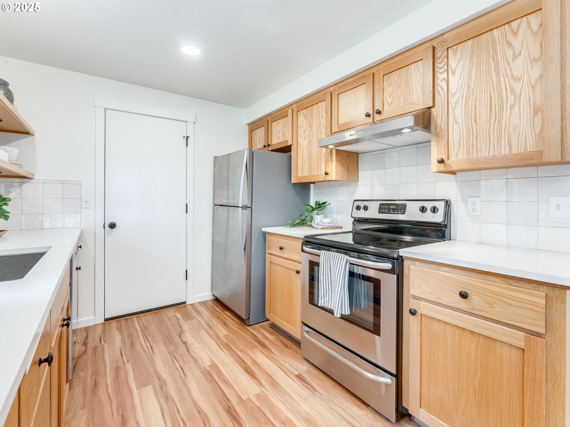 17925 Beebee Court Sandy, OR 97055 - Photo 18 of 48 a kitchen with stainless steel appliances granite countertop a stove a sink and a refrigerator