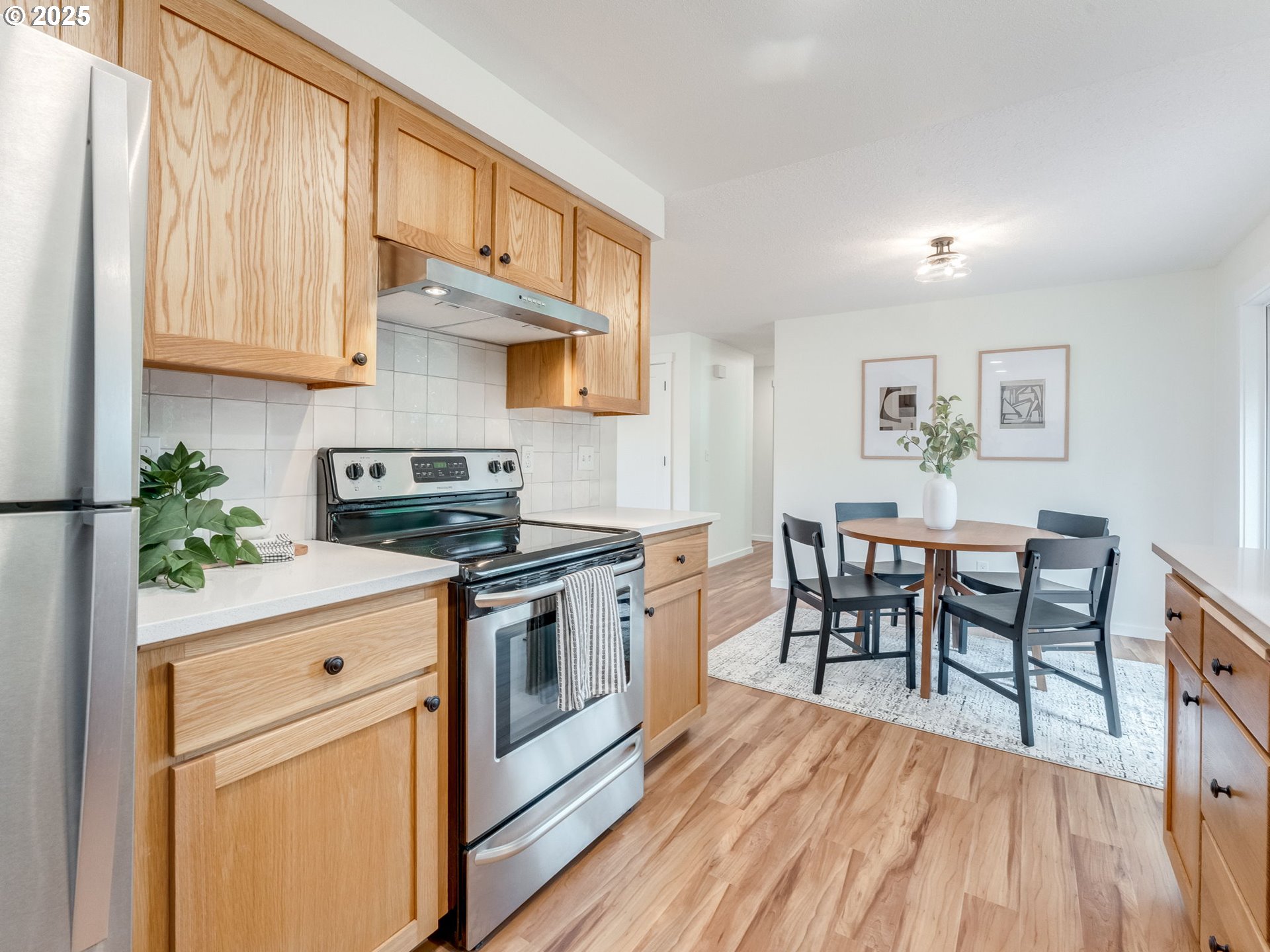 17925 Beebee Court Sandy, OR 97055 - Photo 20 of 48 a kitchen with stainless steel appliances a stove a sink cabinets and a dining table