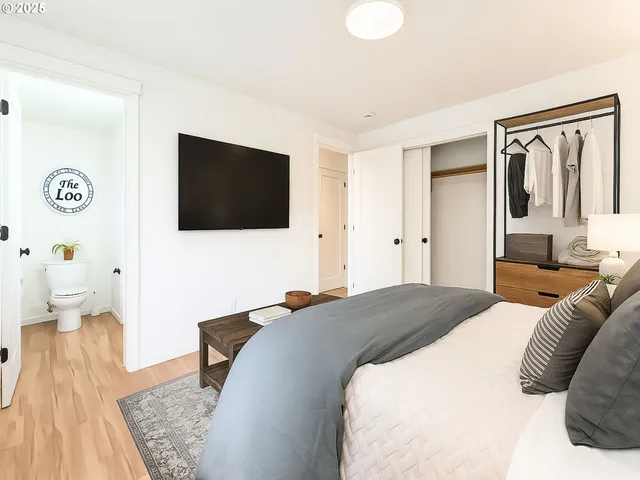 a bedroom with a bed and a flat screen tv