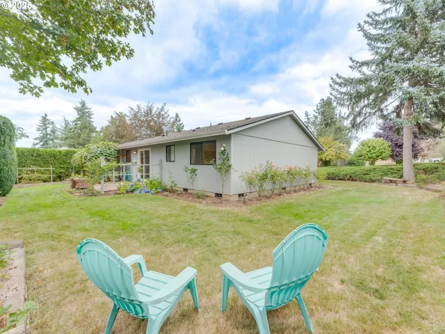 a view of a house with backyard sitting area and garden